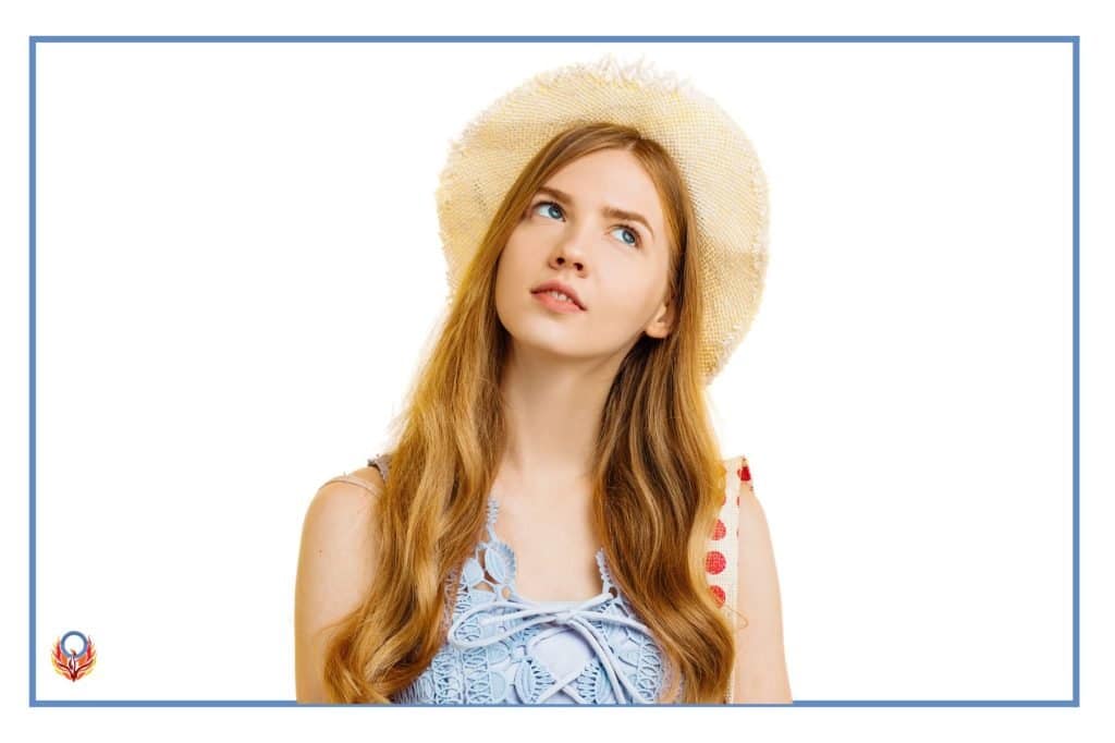 woman in cloth hat looking to the sky with an uncertain look